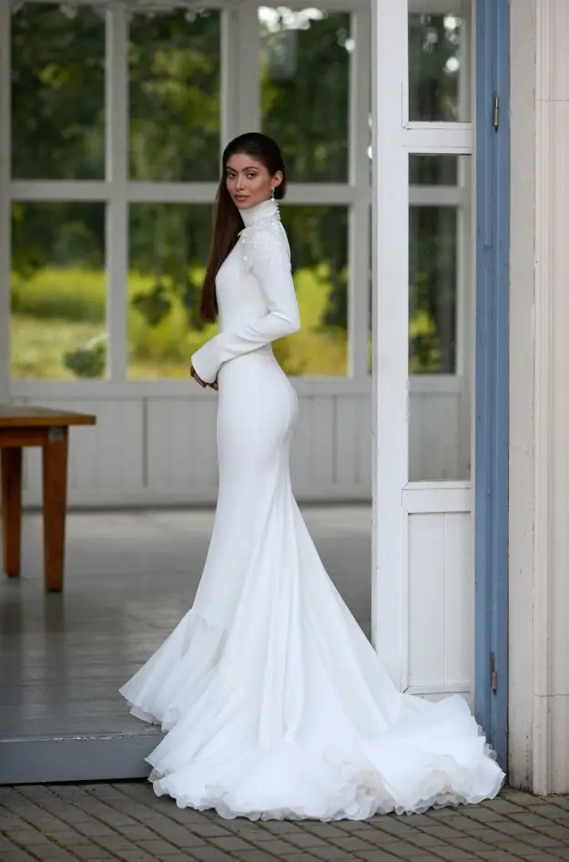 Photo of the smiling model wearing a white gown - Mobile Image